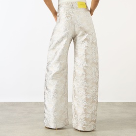 Model wearing Marques Almeida white wide-leg jacquard jeans, back view showing textured metallic floral pattern and high waist.