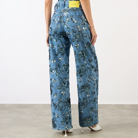 Model wearing Marques Almeida Sequin Embroidered Boyfriend Jeans in mid blue with floral sequin embroidery, high-rise wide-leg silhouette, back view.