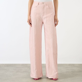 Model wearing Marques Almeida Pink Textured Brocade Boyfriend Jeans, wide-leg silhouette with five-pocket style and brocade finish.