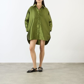 Model wearing Marques Almeida Heavy Fluid Shirt in khaki satin, oversized fit with dipped hem, styled with black loafer flats.