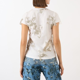 Model wearing Marques Almeida Sequin Embroidered Layered T-Shirt in White Nude, back view, styled with blue floral trousers.