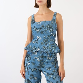 Model wearing Marques Almeida Sequin Embroidered Denim Peplum Top in mid blue with floral embroidery, square neck, wide straps, styled with matching