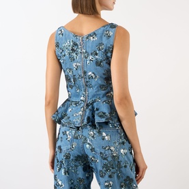 Model wearing Marques Almeida Sequin Embroidered Denim Peplum Top in mid blue, rear view showing concealed zip, styled with matching floral denim