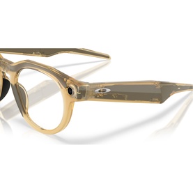 Oakley sunglasses in translucent yellow, round acetate frames with silver logo detail, shown at an angle on white background.