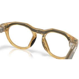 Oakley yellow transparent round-frame glasses with angular keyhole bridge and clear lenses, close-up detail shot.