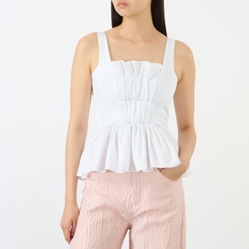 Model wearing Marques Almeida Wrinkled Gathered Top in white with square neckline, shirred detail, and peplum hem, styled with pink trousers