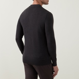 Model wearing Profuomo dark brown wool polo, rear view showing fitted silhouette and ribbed cuffs and hem.