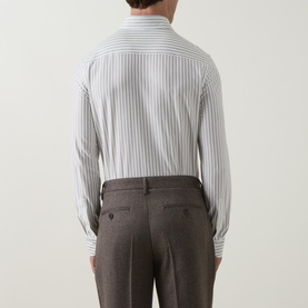 Model wearing Profuomo dark green stripe single cuff regular shirt, back view, styled with brown tailored trousers.