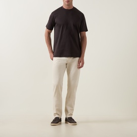 Model wearing Profuomo Solid Logo Pima T-Shirt in brown with crew neck, styled with cream trousers and dark trainers.