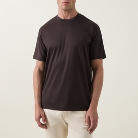 Model wearing Profuomo Solid Logo Pima T-Shirt in brown, crew neck with short sleeves, styled with cream trousers
