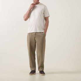 Model wearing Profuomo Solid Logo Pima T-Shirt in Raw White with crew neck, styled with khaki trousers and dark slip-on shoes.