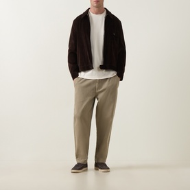 Model wearing Profuomo Solid Logo Pima T-Shirt in Raw White, styled with dark brown jacket, khaki trousers and dark espadrilles.