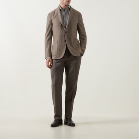 Model wearing Profuomo brown virgin wool blend trousers, styled with a matching brown blazer, grey shirt, and black leather shoes.