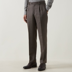 Model wearing Profuomo brown wool-blend trousers with single pleat front, paired with dark leather shoes and grey jumper.