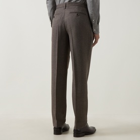 Model wearing Profuomo brown virgin wool blend trousers, rear view, styled with grey shirt and black leather shoes.
