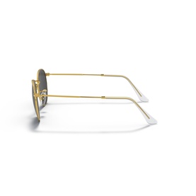 Ray-Ban sunglasses in gold metal frame with grey lenses, shown folded from side angle revealing slim temples with white tips