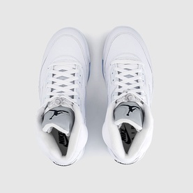 Nike Air Jordan 5 Retro trainers in white with black Jumpman branding and metallic silver detail, overhead view showing lace-up closure