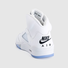 Nike Air high-top trainer in white with black branding and metallic silver translucent sole, rear three-quarter view