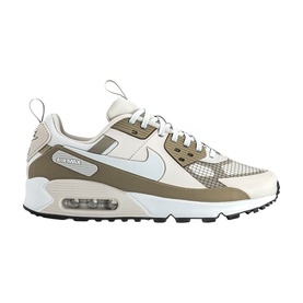 Nike Air Max 90 trainer in light bone and neutral tan, white midsole with visible Air unit, black rubber outsole, mesh and suede upper