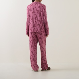 Model wearing Chelsea Peers Modal Giraffe Long Pyjama Set in Giraffe Pink, showing back view of long-sleeve top and wide-leg trousers