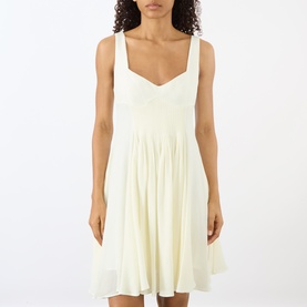 Model wearing JW Anderson Ivory sleeveless mini dress with sweetheart neckline and gathered skirt in viscose-linen blend.