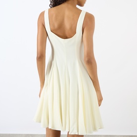 Model wearing JW Anderson ivory sleeveless fit-and-flare dress with scoop back, panelled skirt, viscose-linen blend