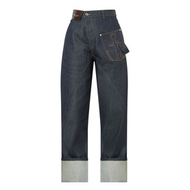 JW Anderson Twisted Wide Leg Trousers in indigo, wide-leg fit with anchor logo stitching, logo patch, and turned-up hem detail.