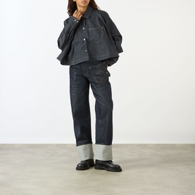 Model wearing JW Anderson Flare Hem Denim Shirt in indigo with matching wide-leg jeans and black chunky loafers