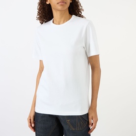 Model wearing JW Anderson Anchor Logo T-Shirt in white, round neck, short sleeves, styled with dark denim jeans.