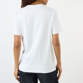 Model wearing JW Anderson Anchor Logo T-Shirt in white, back view, showing round neck, short sleeves, and straight hemline.