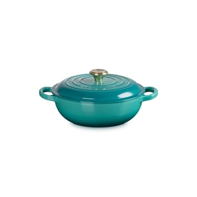 Le Creuset Casserole in Bleu Riviera, shallow cast iron dish with domed lid, gold knob, and twin handles.