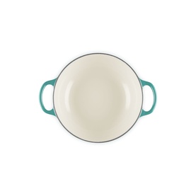Le Creuset Casserole in Bleu Riviera, overhead view showing cream enamel interior and teal twin handles