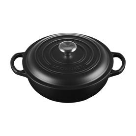 Le Creuset Matte Black cast iron casserole dish with shallow wide base, dual handles, and stainless steel knob lid.