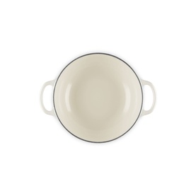 Le Creuset Casserole in Meringue, overhead view showing cream enamel interior and dual handles with dark rim detail.