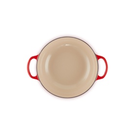 Le Creuset Casserole in Cerise, overhead view showing cream enamel interior and red twin handles