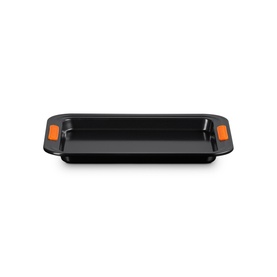 Le Creuset Small Baking Tray 27cm in Satin Black, rectangular non-stick carbon steel with orange heat-resistant silicone handles
