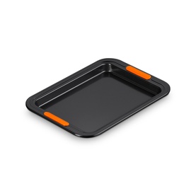 Le Creuset Small Baking Tray 27cm in Satin Black, rectangular non-stick carbon steel with orange silicone handles and rim inserts