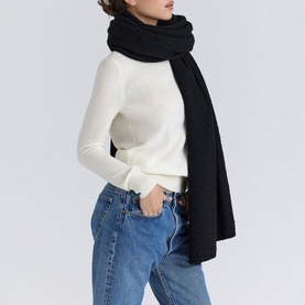 Model wearing House of CB ivory knit jumper, styled with black oversized scarf and blue denim jeans