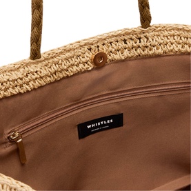 Whistles woven raffia tote bag interior, showing beige fabric lining, zip pocket, and gold-tone clasp detail with rope handles.