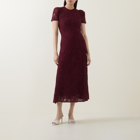 Model wearing Rotate Decadent Chocolate lace midi dress with short sleeves and flared skirt, styled with silver heeled mules