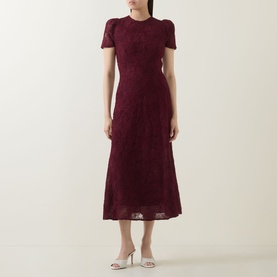Model wearing Rotate Decadent Chocolate lace midi dress with short sleeves and fitted waist, styled with silver heeled mules.