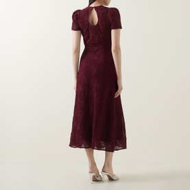 Model wearing Rotate Decadent Chocolate lace midi dress, short sleeves, keyhole back detail, A-line skirt, styled with nude heels.