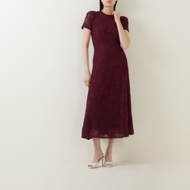 Model wearing Rotate Decadent Chocolate lace midi dress with short sleeves and flared skirt, styled with cream heeled mules