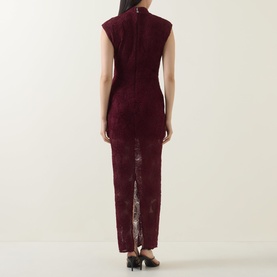 Model wearing Rotate Dress in Decadent Chocolate, back view, sleeveless lace maxi with high neck and centre back split, styled with black heels.