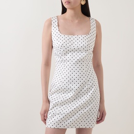 Model wearing Rotate Dress in Egret polka dot print, sleeveless mini length with square neckline and fitted silhouette