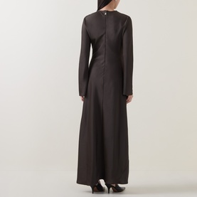 Model wearing Rotate Black Olive maxi dress, long sleeves, fitted bodice, shown from the back with subtle sheen finish