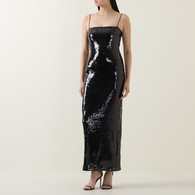 Model wearing Rotate black sequin maxi dress with thin straps and fitted silhouette, styled with black heeled sandals