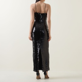 Model wearing Rotate black sequin midi dress, shown from behind, featuring thin straps and a side split