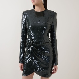 Model wearing Rotate Black Olive sequin mini dress with long sleeves, crew neck, and ruched wrap-style skirt detail.