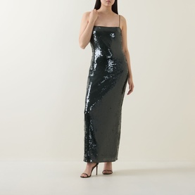 Model wearing Rotate Black Olive sequin maxi dress with thin straps and column silhouette, styled with black strappy heels